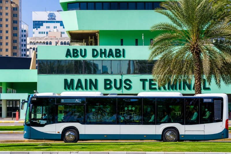 Bus passing in front of Abu Dhabi Main Bus Terminal building