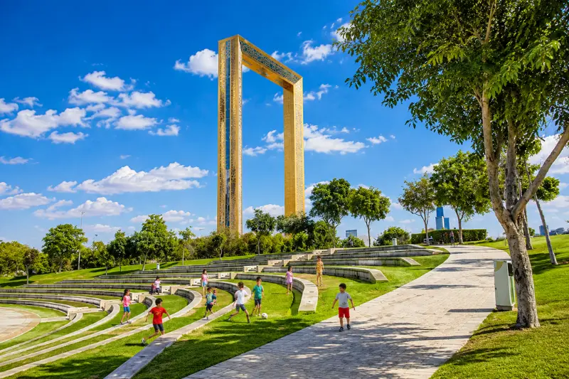 Children playing near Dubai Frame at Zabeel Park Dubai