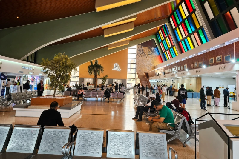 Passengers waiting inside Abu Dhabi Central Bus Station terminal hall