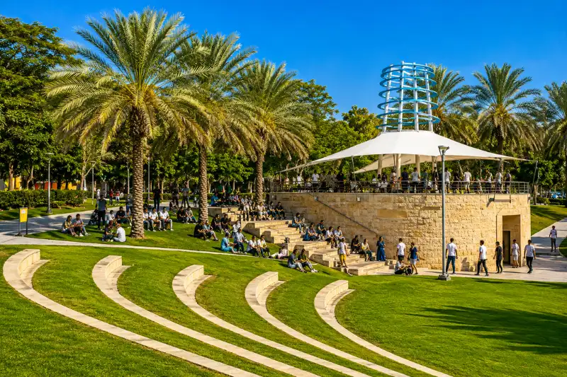 People relaxing in the amphitheatre area at Zabeel Park Dubai