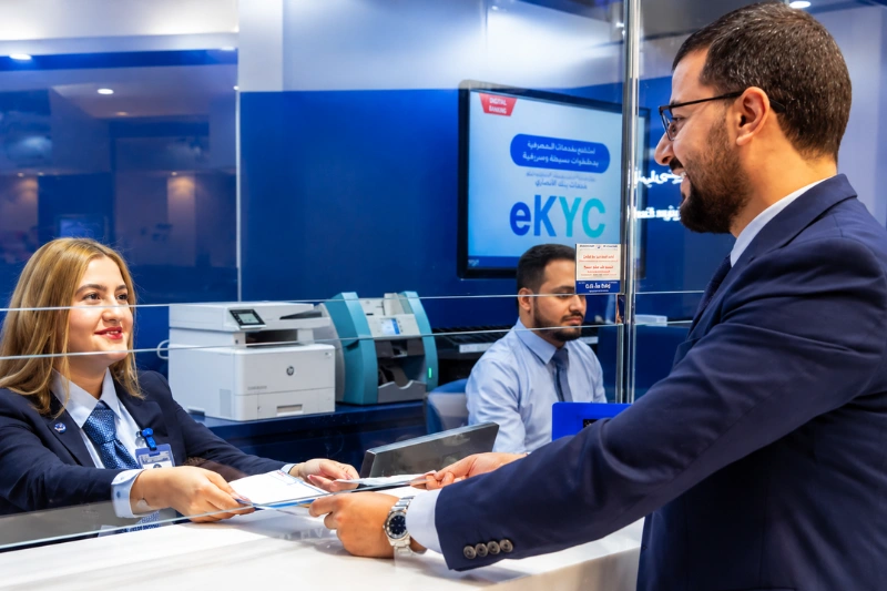 Customer completing transaction at Al Ansari Exchange