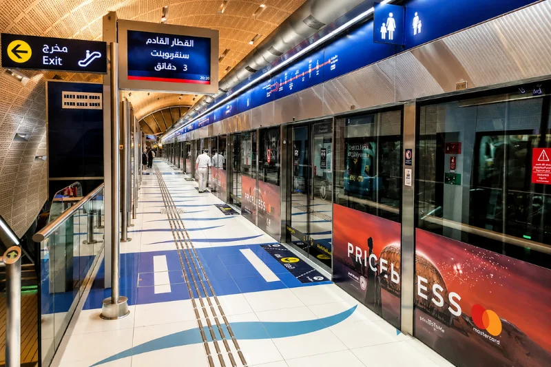 Dubai Internet City Metro Station platform with train doors and directional signs