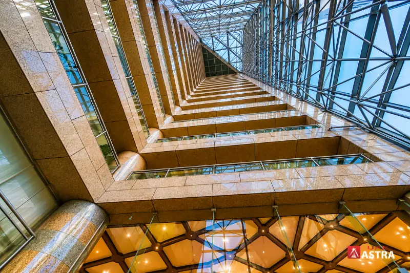Interior atrium view of Sheikh Khalifa Energy Complex with glass roof and modern architecture
