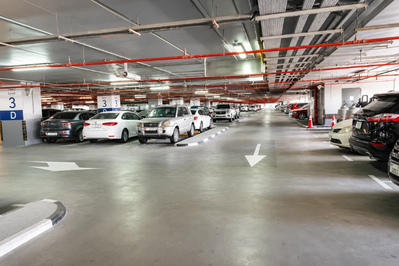 Park-and-Ride parking area at Rashidiya Metro Station with rows of parked vehicles