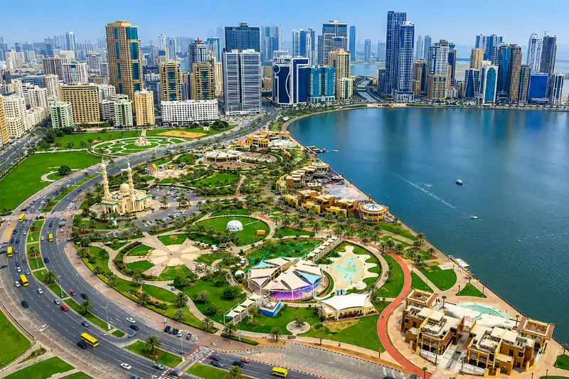 Aerial view of Al Majaz Waterfront near Al Qasimia featuring Khalid Lagoon, parks, and the Sharjah skyline