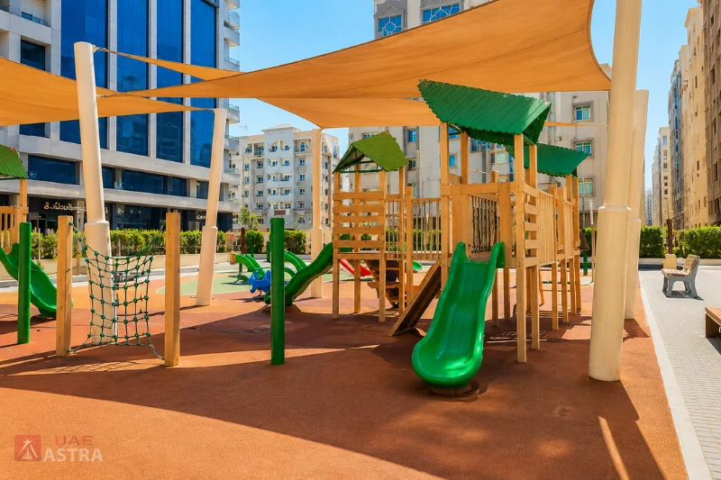 Children's playground with shaded play equipment at Muwaileh Park, Sharjah