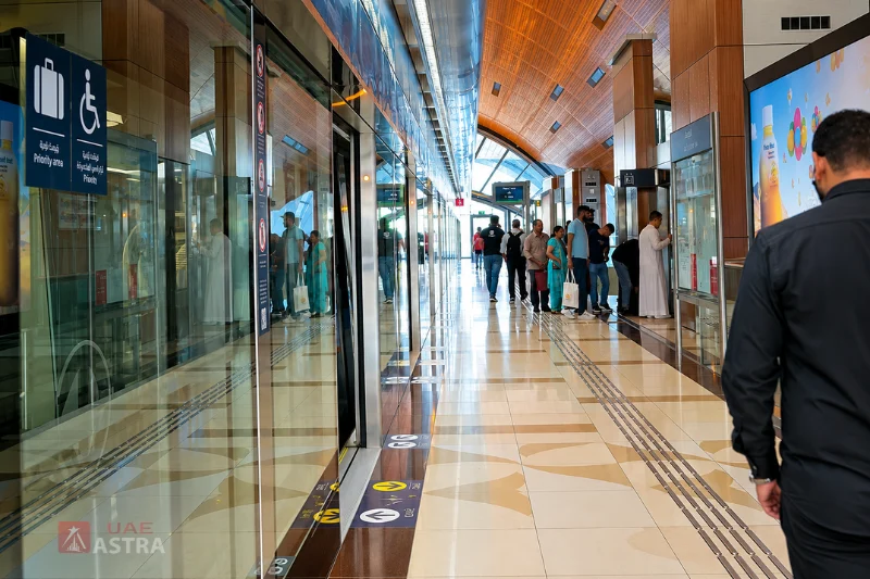Dubai Metro passengers waiting inside Al Qiyadah Metro Station platform with modern facilities and accessible boarding area