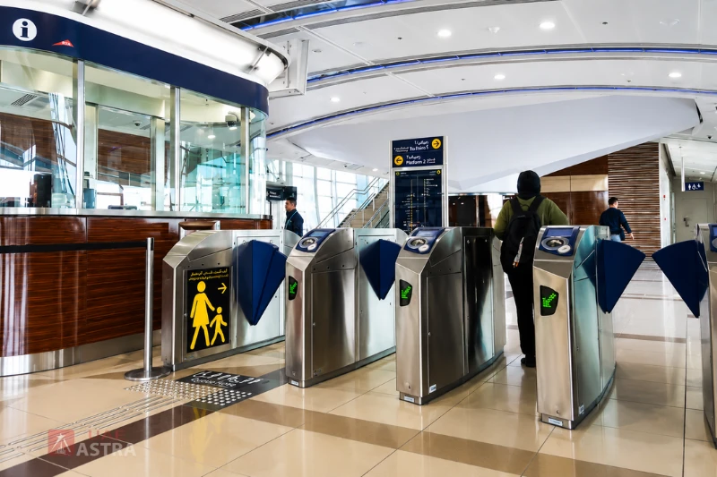 Entry gates and customer service area inside Al Qiyadah Metro Station with platform access signs