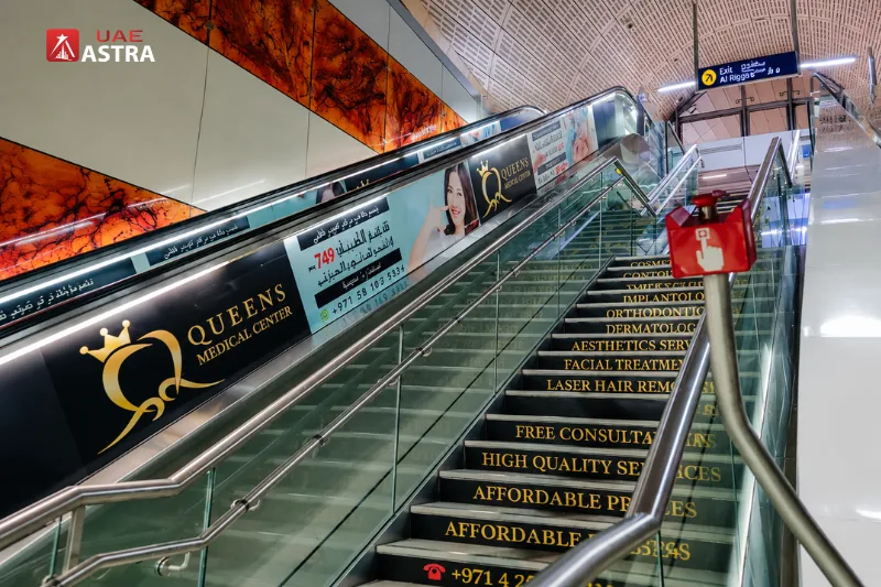 Escalators and stairs inside Al Rigga Metro Station with clear exit signs and accessible passenger facilities