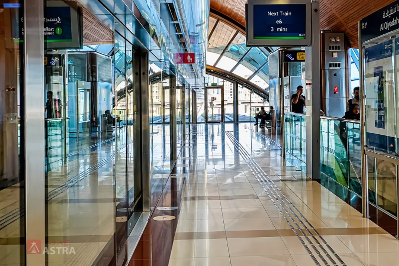 Interior view of Al Qiyadah Metro Station platform showing passenger waiting area and train information displays