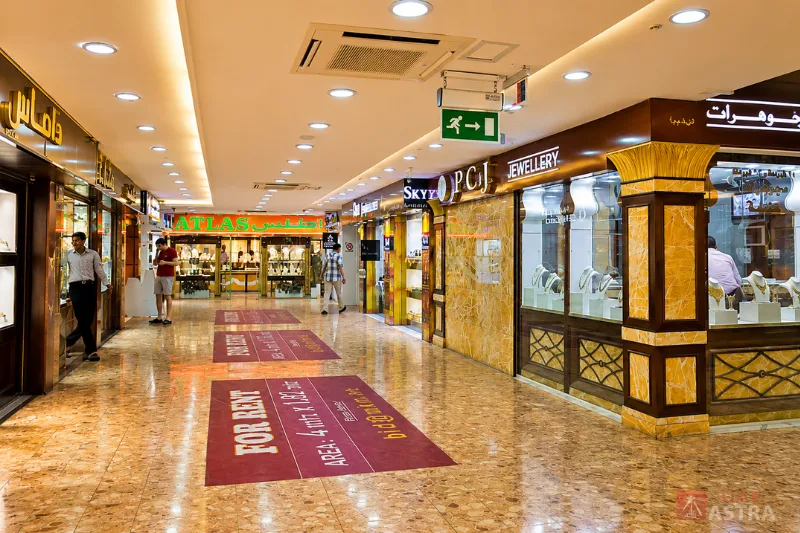 Interior walkway of Dubai Gold Souk lined with jewellery shops and gold retail stores