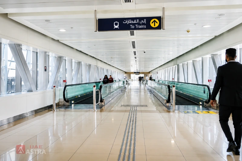 Pedestrian walkway inside Al Qiyadah Metro Station leading to train platforms with moving walkways