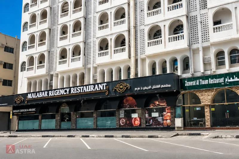Restaurants and street-level dining options in Abu Shagara Sharjah beneath a residential apartment building