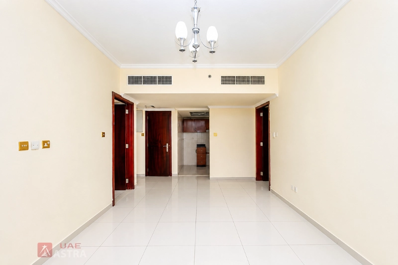 Spacious apartment living room interior in Al Qasimia Sharjah with modern tiled flooring and bright layout