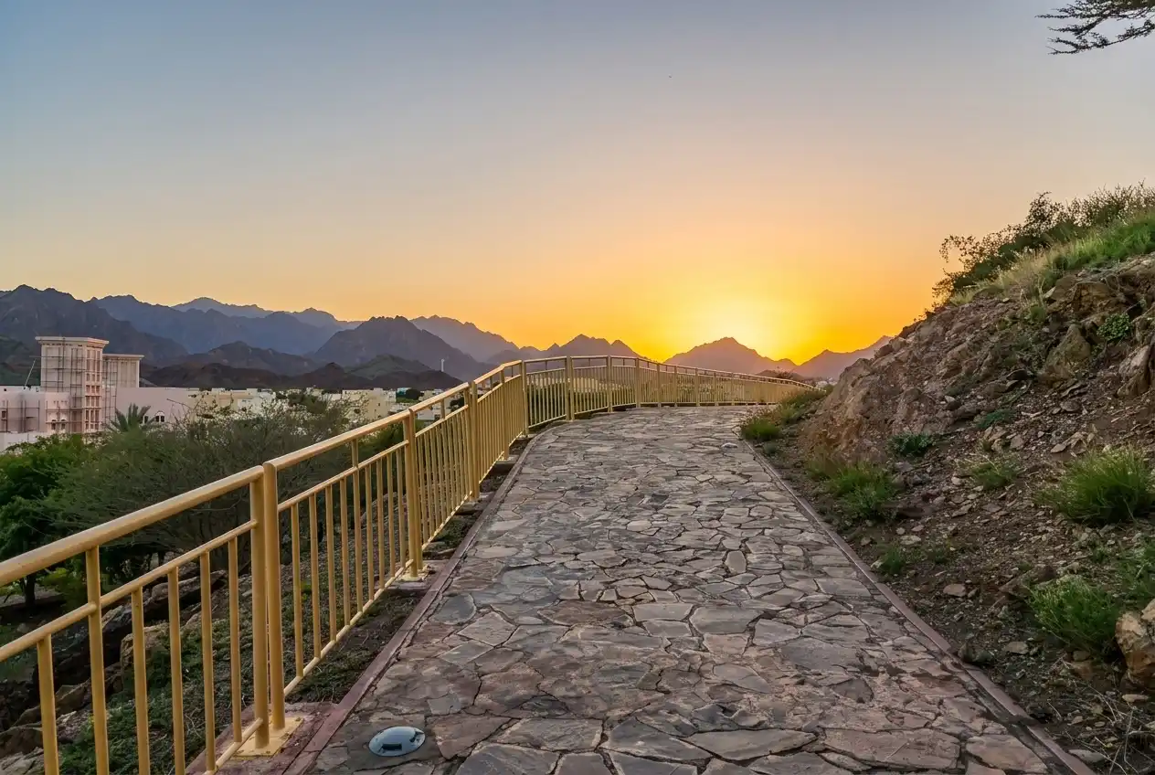 Stone walking trail at Hatta Hill Park with panoramic mountain sunset views