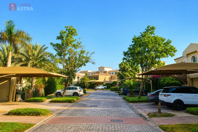 Tree-lined residential street with spacious villas in Green Community West Dubai