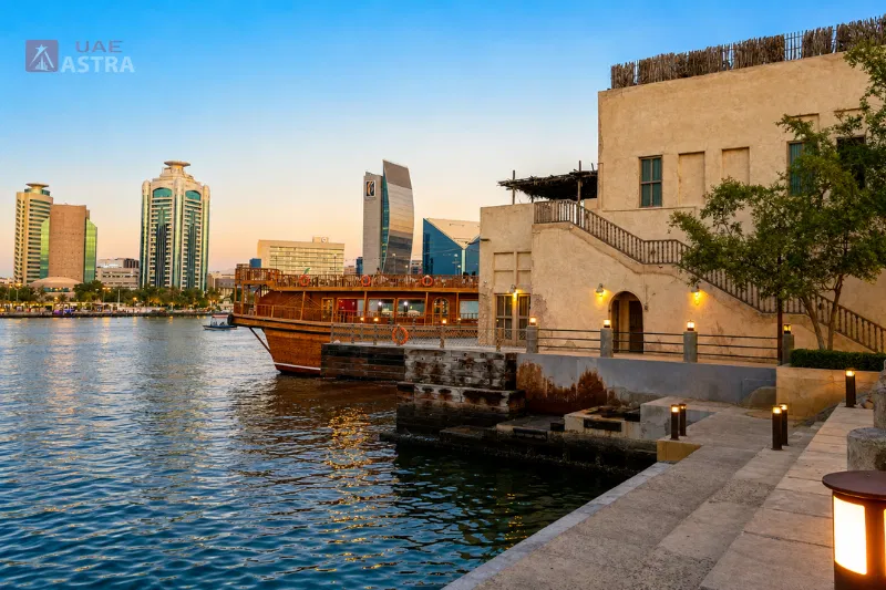 Dubai Creek waterfront with a traditional dhow and heritage building