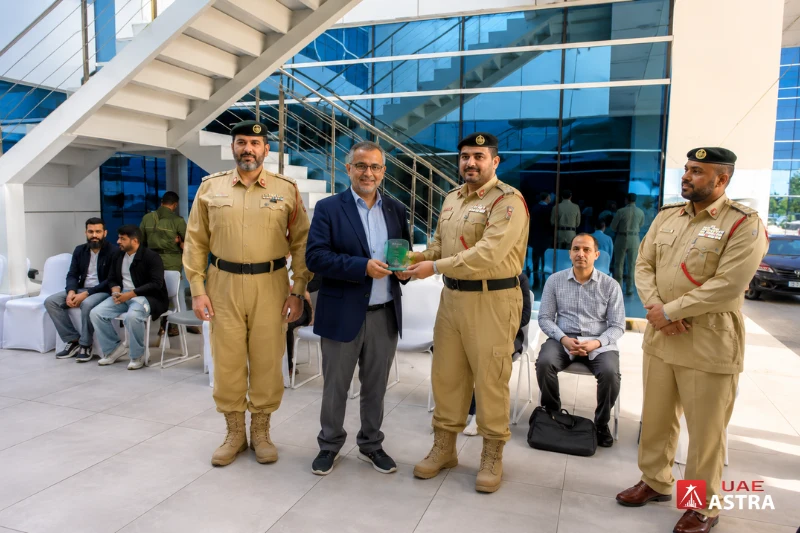 Dubai Police officers presenting an award at a police station event