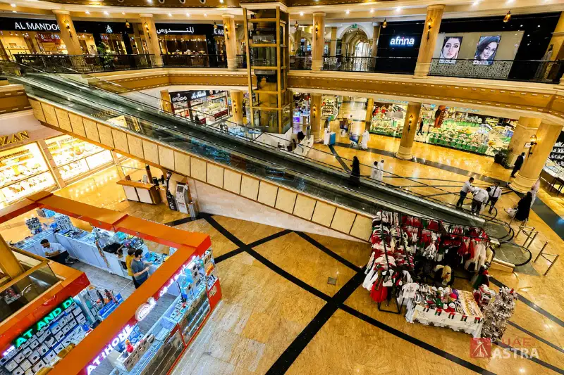 Etihad Mall Dubai interior with escalators and multiple shops