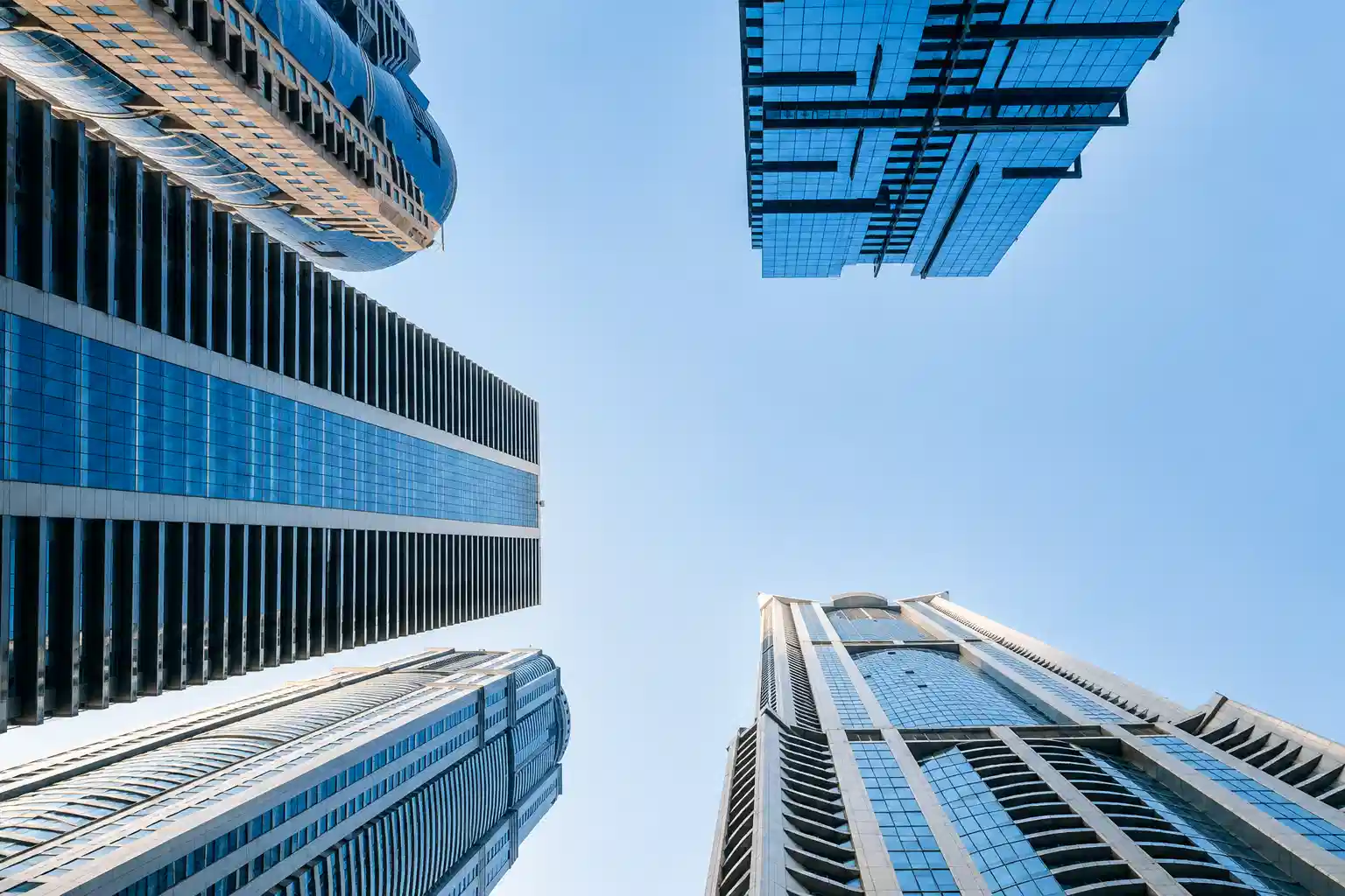 Modern skyscrapers viewed from below against a clear sky