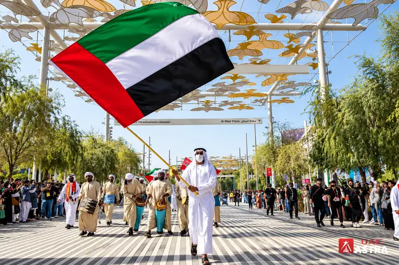 UAE National Day parade with UAE flag and traditional performers
