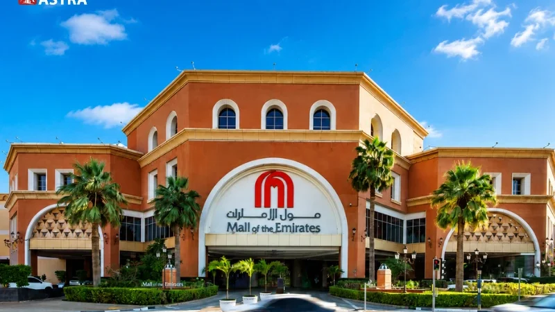 Mall of the Emirates Dubai entrance with palm trees and road view