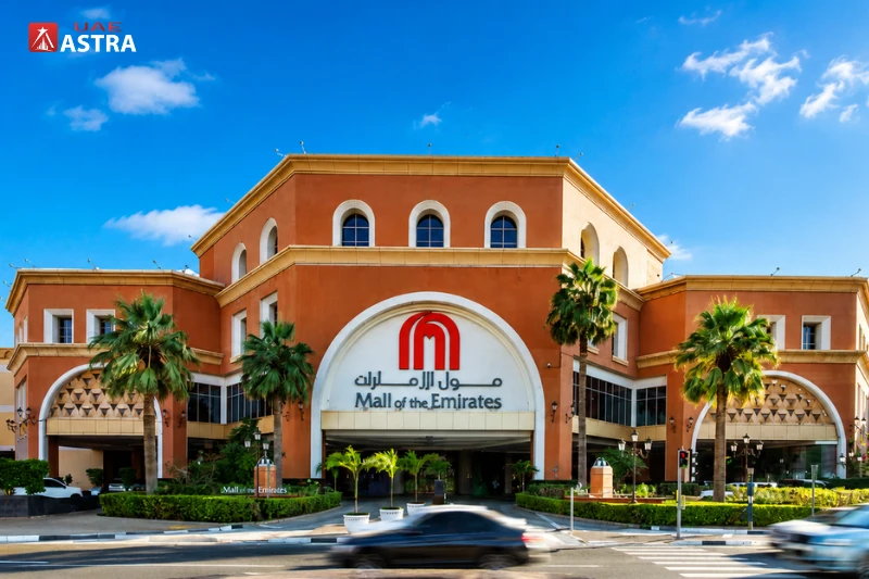Mall of the Emirates Dubai entrance with palm trees and road view
