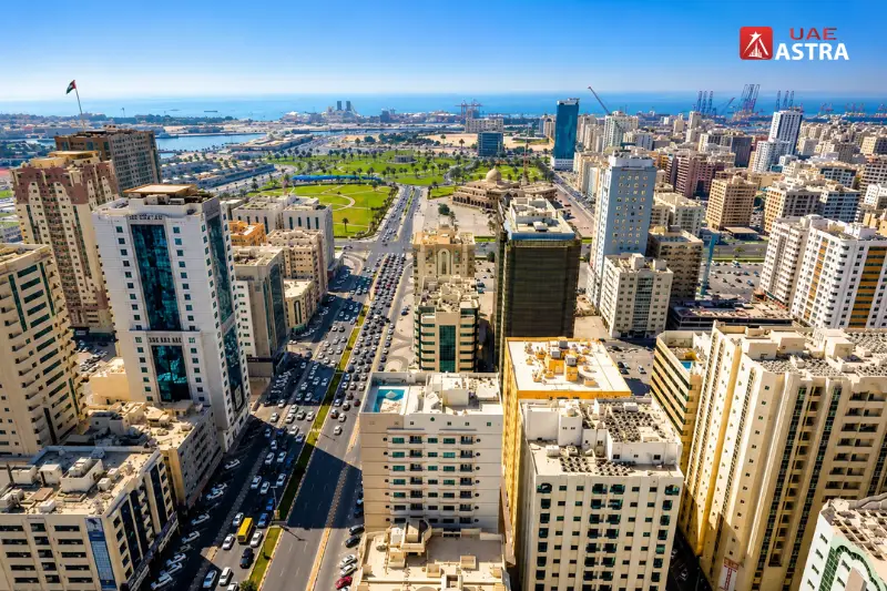 Aerial view of Al Qasimia Sharjah showcasing apartment towers, main roads, and the surrounding urban landscape
