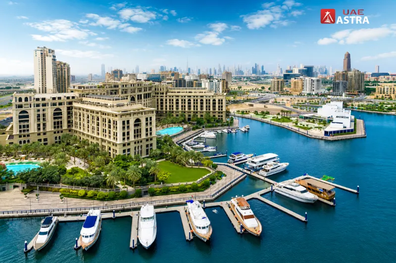 Aerial view of Jaddaf Waterfront featuring luxury hotels, Dubai Creek marina, yachts, and the modern Dubai skyline