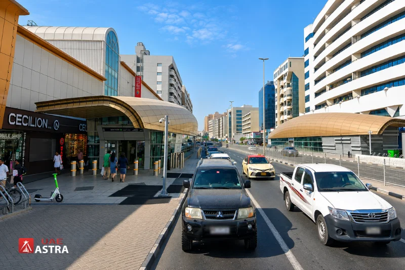 Street view of Salah Al Din Metro Station with Green Line entrances and surrounding commercial buildings in Deira, Dubai