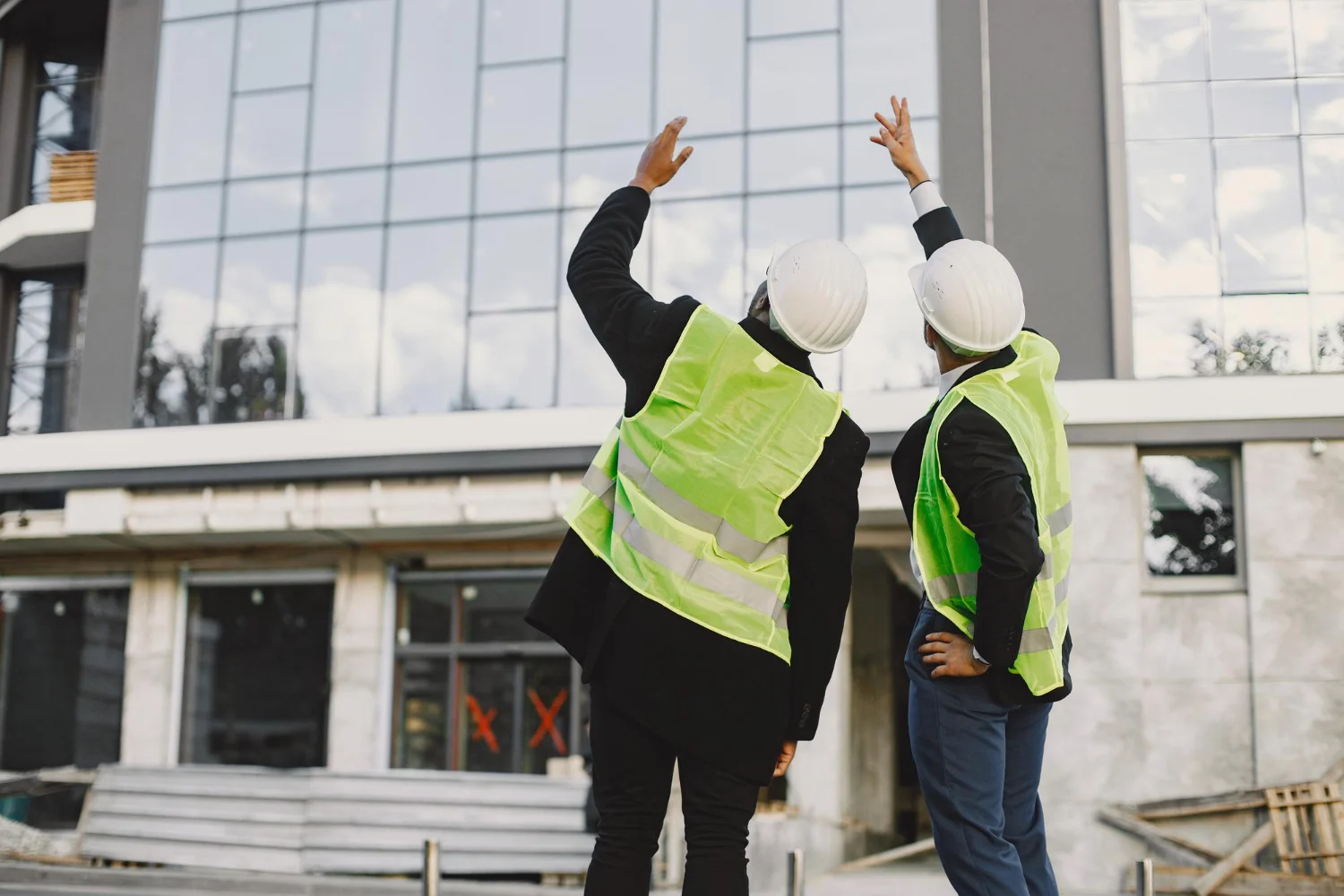 Construction workers reviewing a building renovation