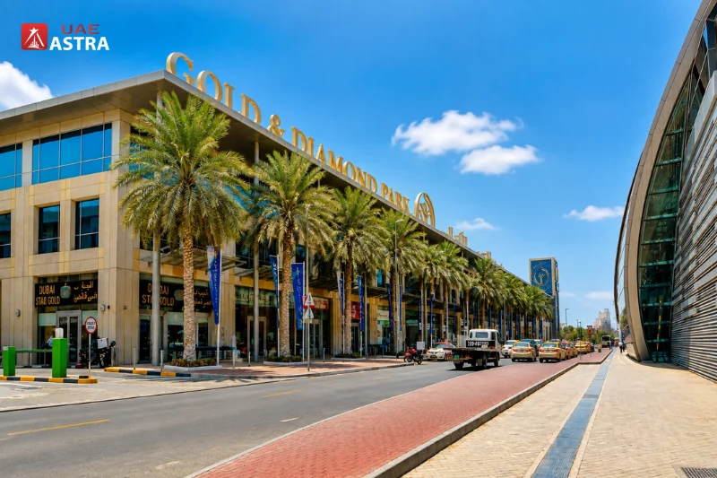 Exterior view of Gold and Diamond Park Dubai with palm-lined shops and direct Metro station access