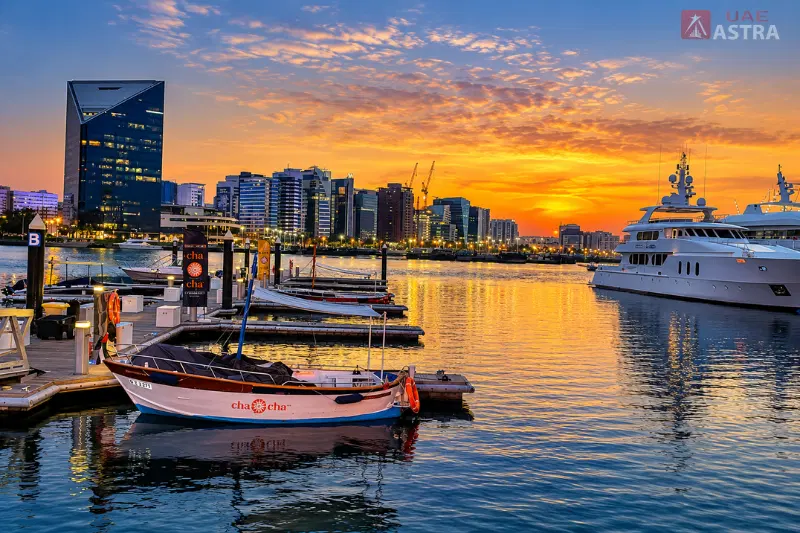 Dubai Creek Harbour marina at sunset with yachts, waterfront docks and a modern city skyline