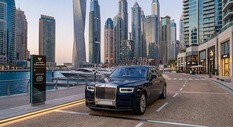 Black chauffeur car at Dubai Marina skyline