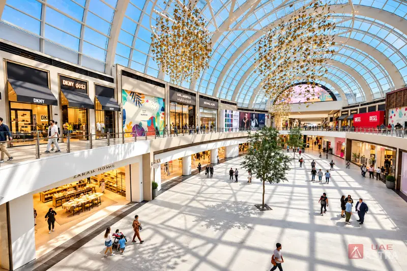 Dubai Hills Mall interior atrium with glass roof, fashion stores and shopping walkways